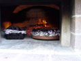 Inside the dome roasting chicken in covered pots.