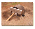 Adobe mud wood oven heated and closed for baking test.