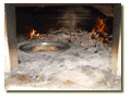 Picture of the same pizza being fired.