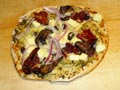 Making a vegetalian pizza with the feta cheese.