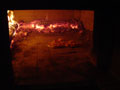 Evening picture of a love heart pizza being fired.
