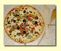 Pizza ready to put into the wood oven.