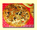 Finished pizza with many olives.