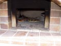 Picture of 3 pizzas being cooked at ones.