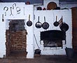 Photograph of fireplace and wood firing oven in an old cottage kitchen.