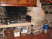 Indoor oven and fireplace in the room.