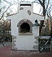 Plaster finish applied to outdoors brick oven.