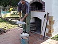 Ash is out from brick oven, put it into the metal bucket.